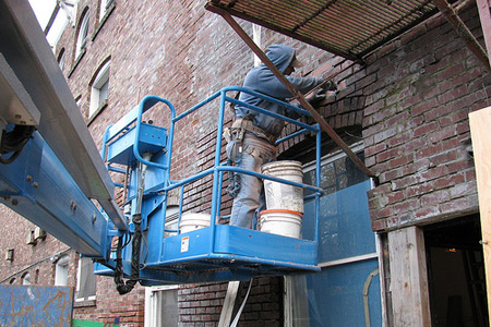 Image of man repairing exterior brickwork